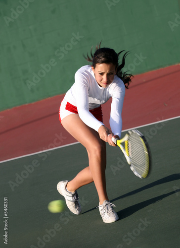 Teenage girl playing tennis © Galina Barskaya