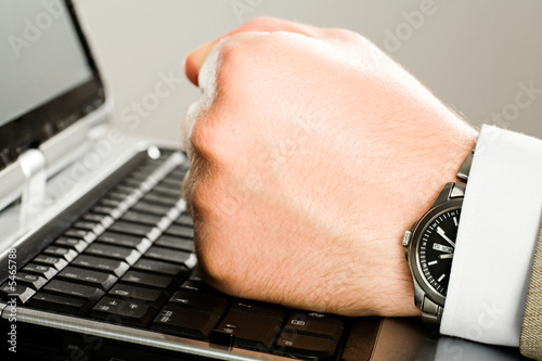 Photography Human  fist on the keyboard of laptop