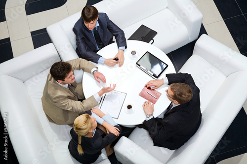 Businesspeople sitting around at the table  photo