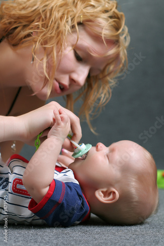 Cute family - mother takes care about angel like child