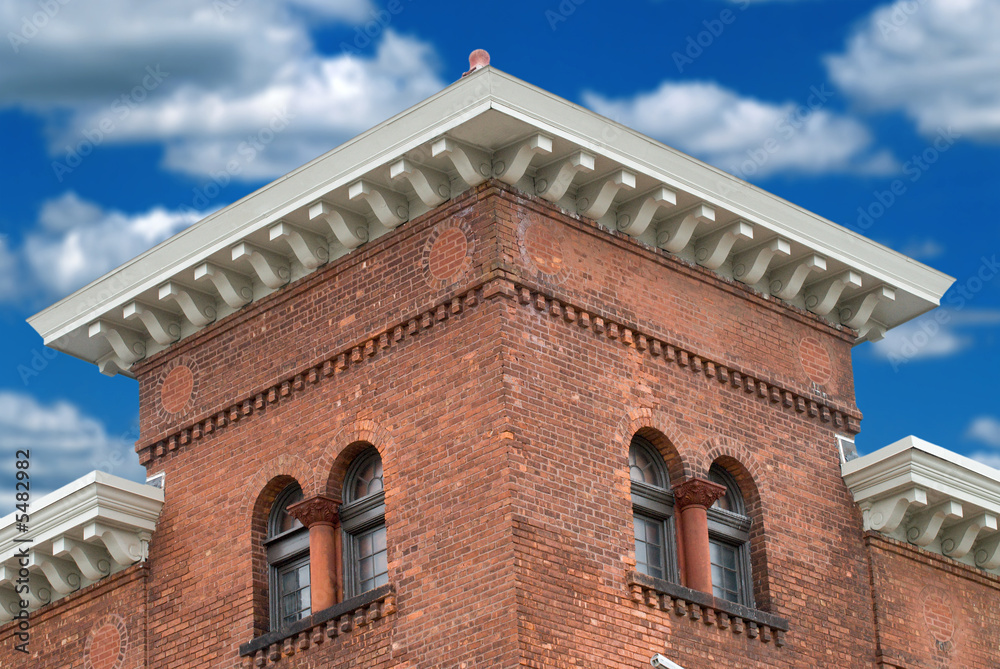  urban Brick building with a blue sky and clouds