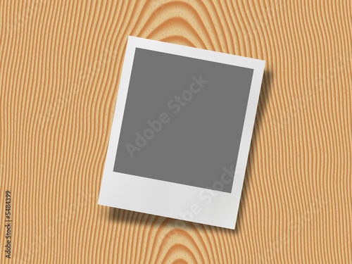 polaroid photo frame on wood background