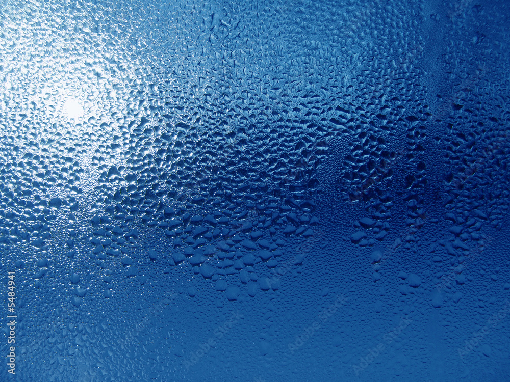 Close-up clear drops of water on window glass surface