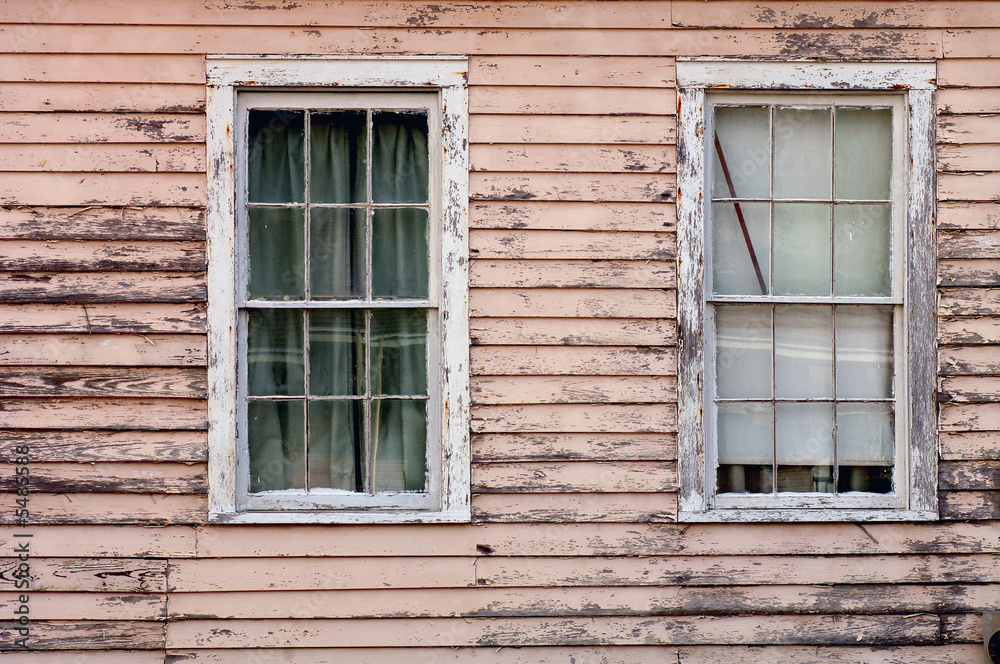 Image of weathered southern home with two windows