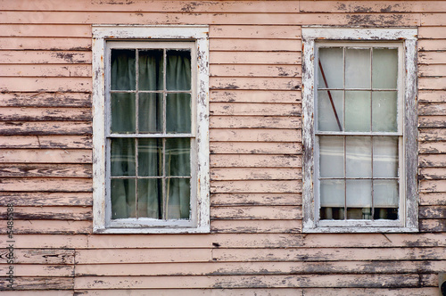 Image of weathered southern home with two windows