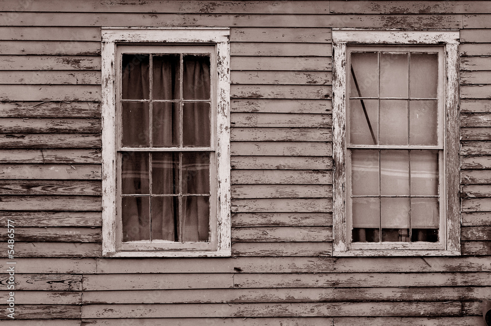 Image of weathered southern home with two windows