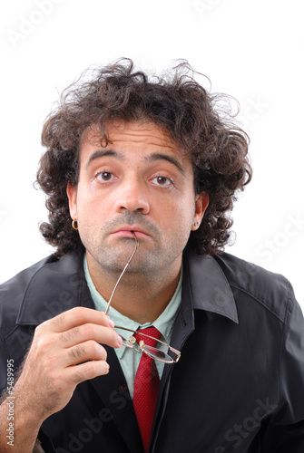 Photo of a thoughtful man holding his glasses photo