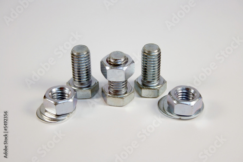 Fotografie nuts and bolts over a white background