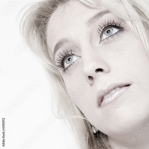 Studio portrait of a long blond girl looking up