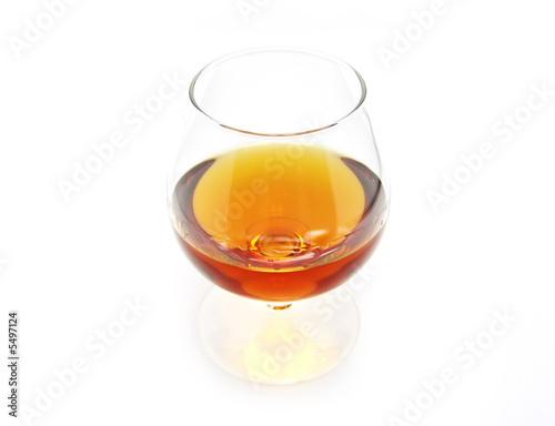 Glass of cognac on a white background