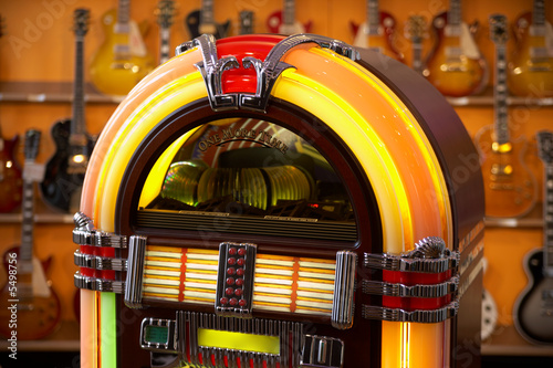 jukebox in front of guitars - selective focus on jukebox photo