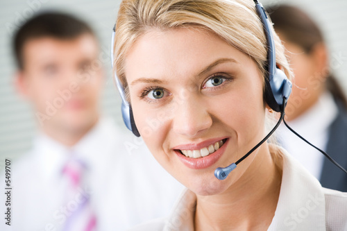 Face of young charming confident woman with headset