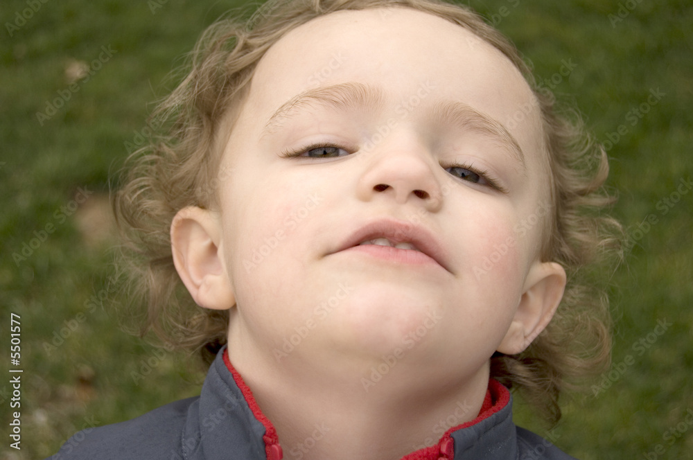 young boy with head tilted backwards to show nose young boy with head tilted backwards to show nose