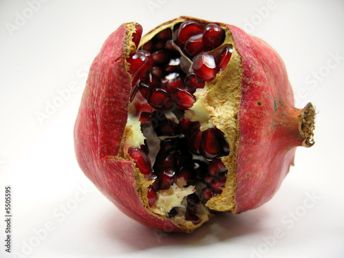 a pomegranate split open revealing its seeds