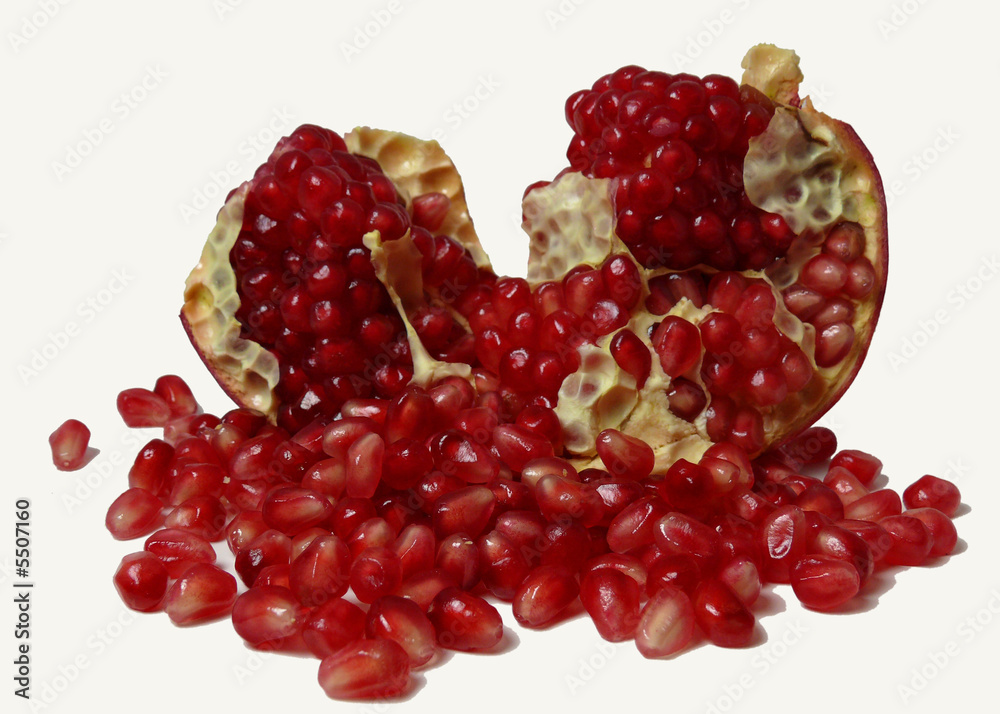 seeds spilling out of a pomegranate, isolated on white. seeds spilling out of a pomegranate, isolated on white.