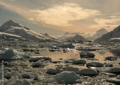 sunset over ice in antarctica.