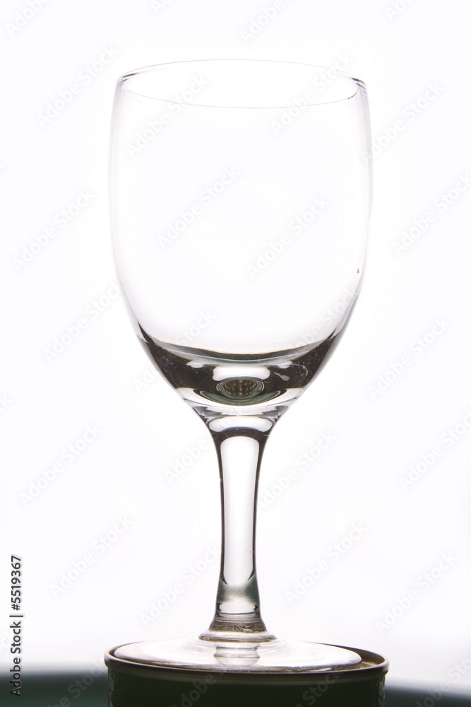 A single winegalss silhouette in plain white bacground.