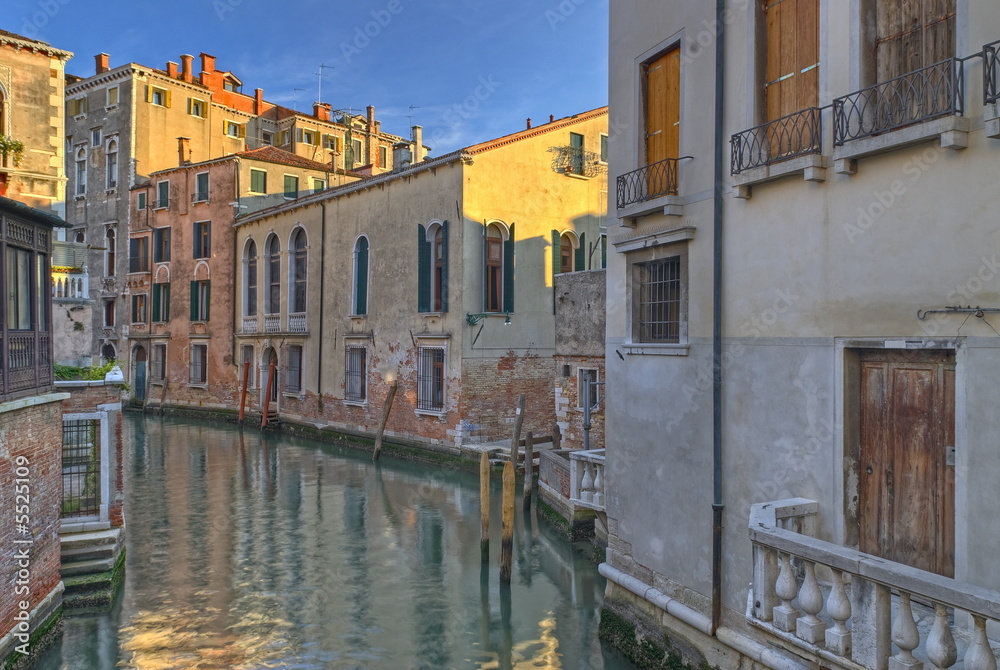 A typical canal in Venice with beautifully colored houses.