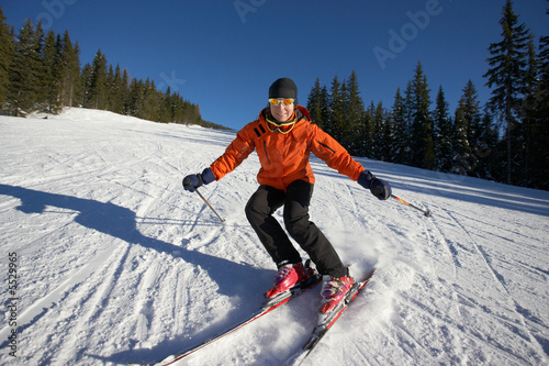 female skier carving on an empty slope