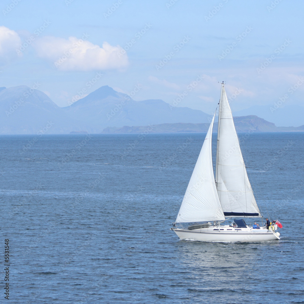 Sailing boat with Scottish Island on the horizon