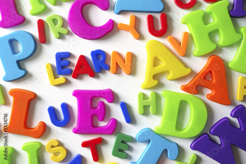Composition of colorful plastic toy letters and word LEARN