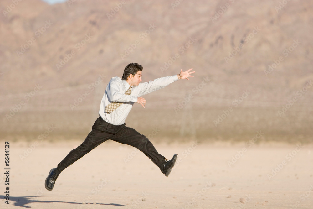 Happy businessman jumping in air Happy businessman jumping in air