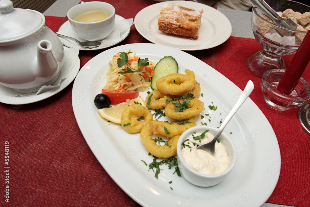 The dinner in the restaurant, main course - calamaries The dinner in the restaurant, main course - calamaries