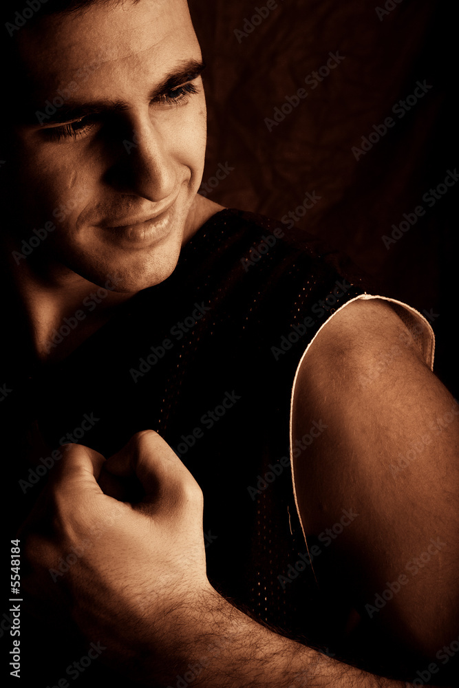 handsome young man on dark background
