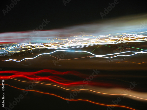 Canvas Print Abstract light trails from cars, signs, and other landmarks.