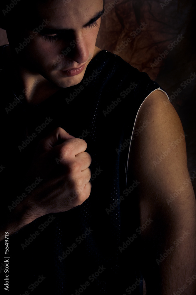 young man profile on dark background