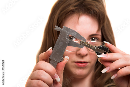 Billede på lærred Woman with trammel measured key isolated on white background
