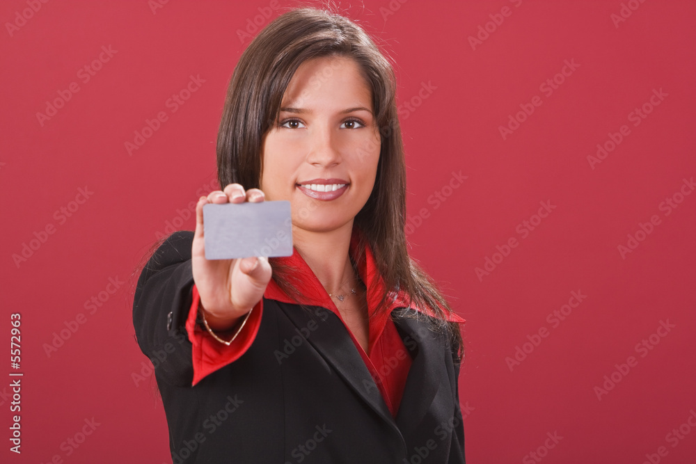 Young brunette offering a credit card-focus on face Young brunette offering a credit card-focus on face