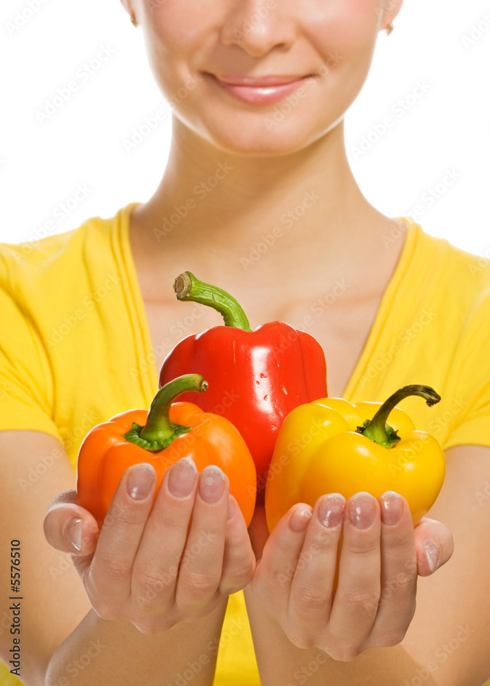 Girl holding sweet colorful peppers in her hands Girl holding sweet colorful peppers in her hands