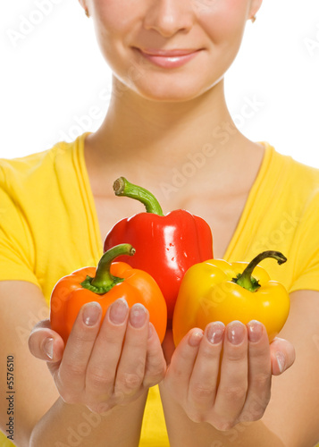 Girl holding sweet colorful peppers in her hands