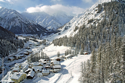 little village between high mountains in winter