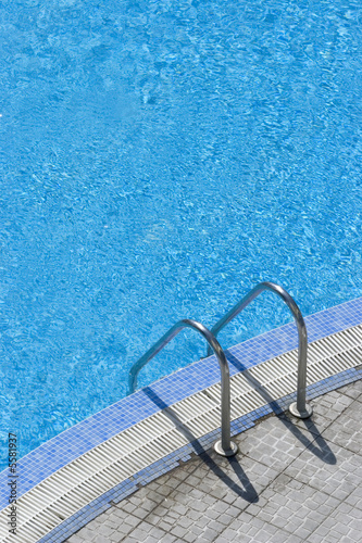 steps into hotel swimming pool summer time 