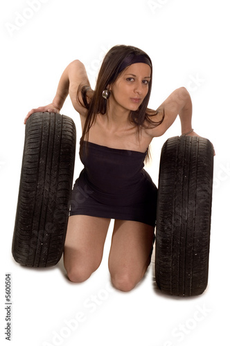 Young sexy girl holding a car wheel photo