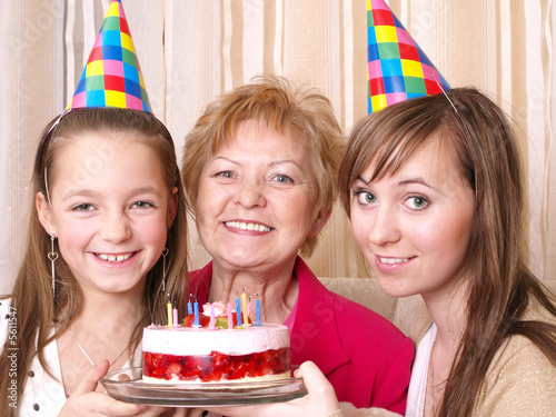 Daughter, mother and grandmother with birthday cake