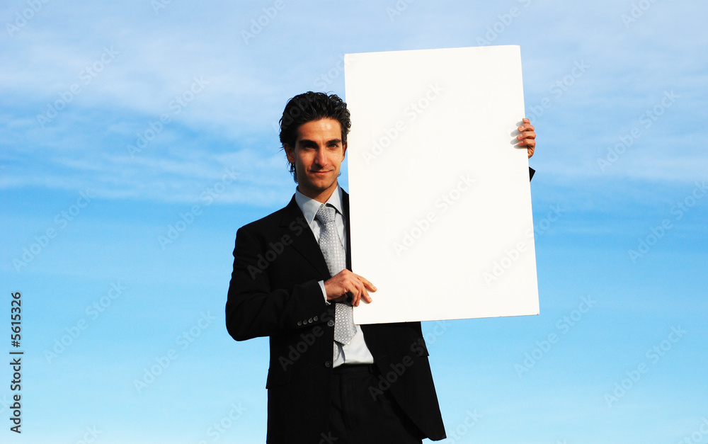confident and successful businessman is holding a blank board confident and successful businessman is holding a blank board