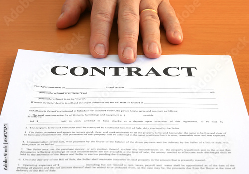 Male hand presents a contract document