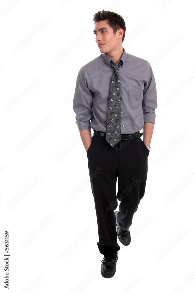 A well dressed man walking with his hands in pockets Stock Photo