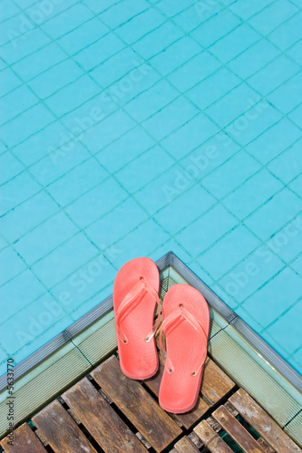 Red flip flops by the pool.