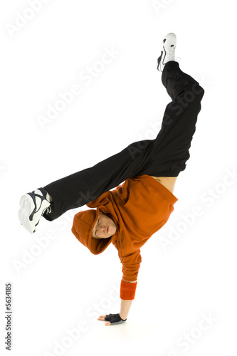 Young hooded bboy standing on one hand.  photo