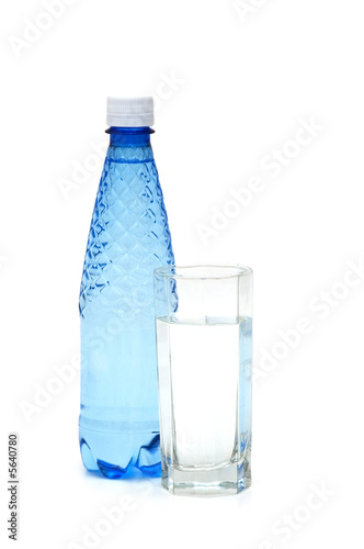 Glass and bottle of water isolated on white