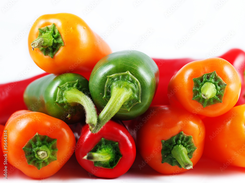 Mixed sweet and chilli peppers over white background Mixed sweet and chilli peppers over white background