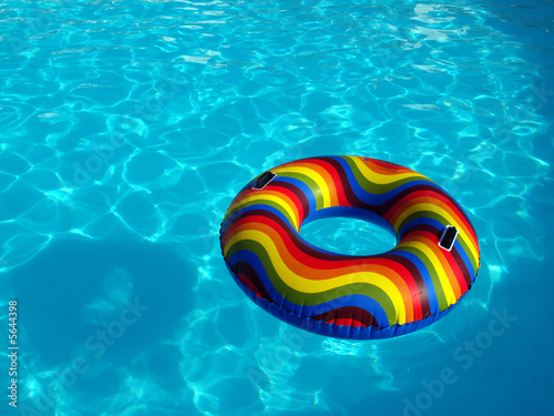 Swimming pool with a brightly coloured inflatable ring.