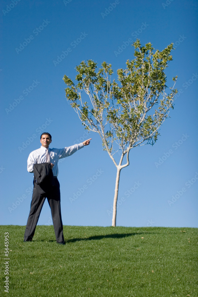 Businessman in dark suit pointing with his finger Businessman in dark suit pointing with his finger