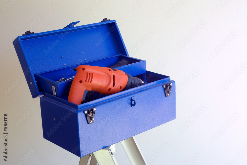 Blue diy home improvement toolbox with orange drill Blue diy home improvement toolbox with orange drill