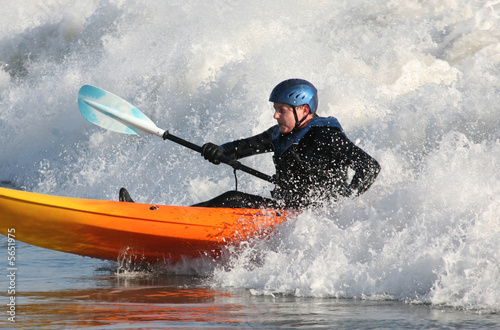 Kayak surfer paddling in rough seas © Joe Gough