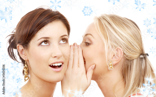 two happy young girlfriends with twinkles and snowflakes